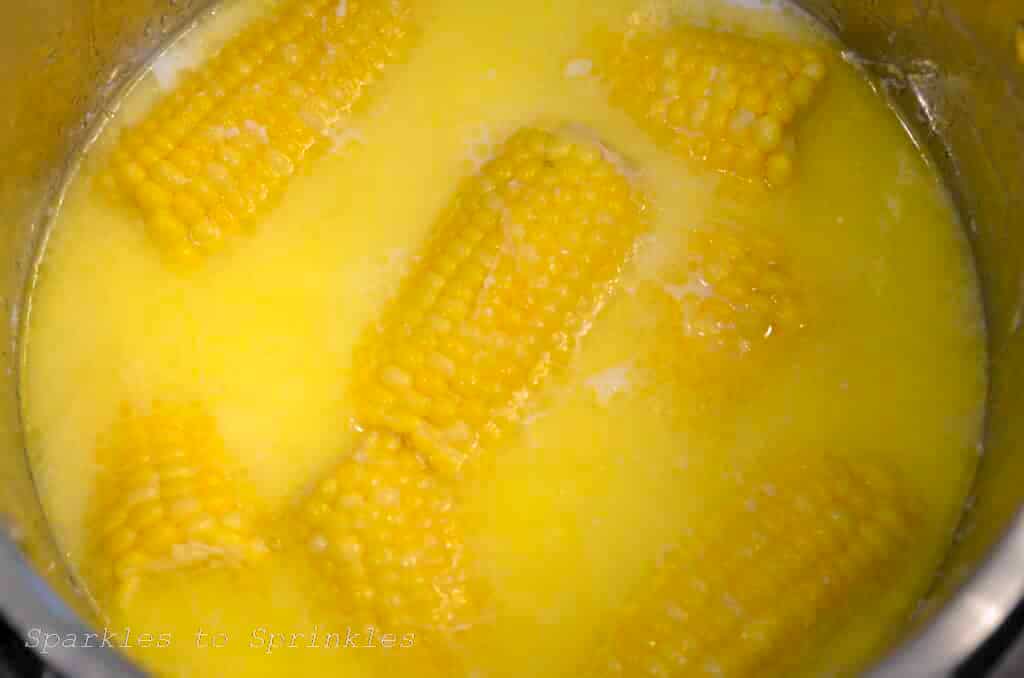 corn on the cob with milk in a pot