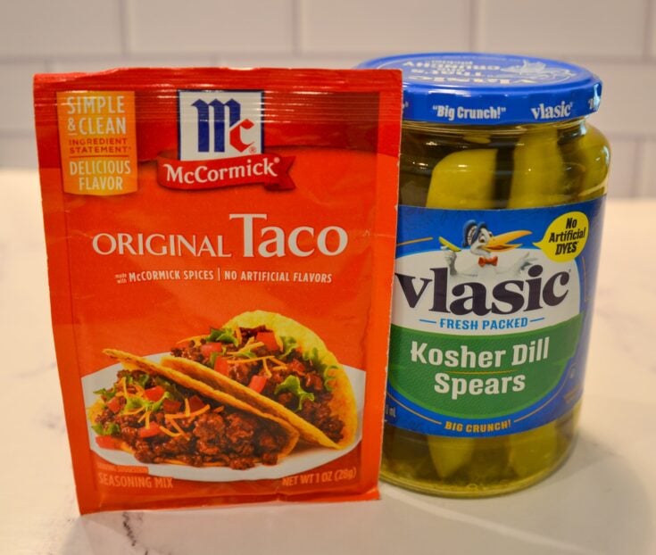 taco seasoning packet leaning on a pickle jar