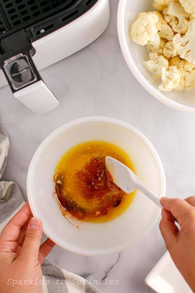 In a small bowl add your melted butter, buffalo sauce, ½ teaspoon garlic powder and smoked paprika and mix